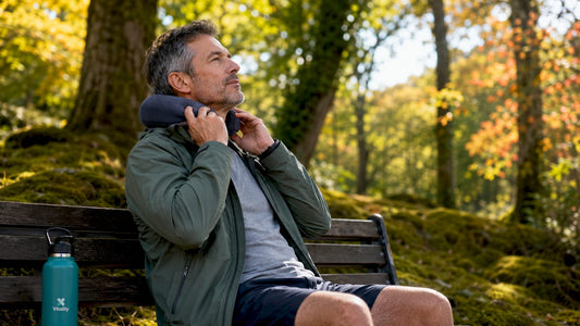 Man adjusting neck pillow during car travel