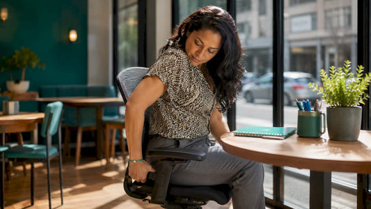 Woman adjusting office chair for better posture