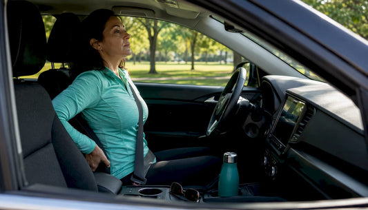 Driver adjusting posture in car seat
