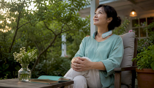 Woman using wireless neck therapy device at home