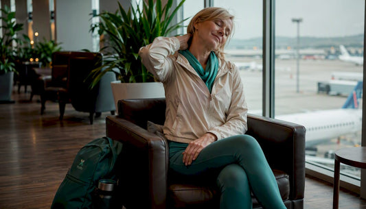 Traveler doing neck stretches at train station