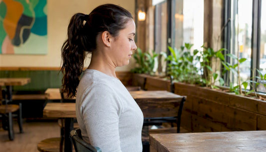 Person doing chin tuck neck exercise