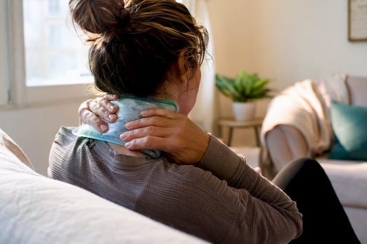 Hands applying cold pack to neck area