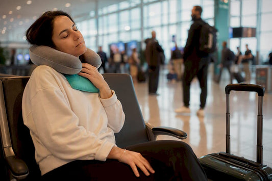 Traveler using travel pillow to relieve neck pain