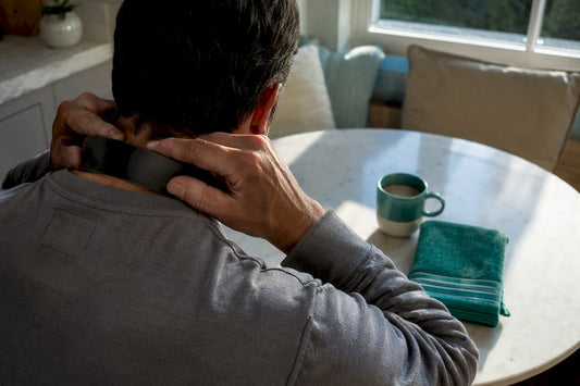 Person using a neck massager at home